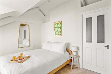 The bedroom is light and airy.