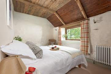 Bedroom 1 retains a lot of its original features. Embrace the historic character of Peaceful Retreat and snuggle up with an old novel.