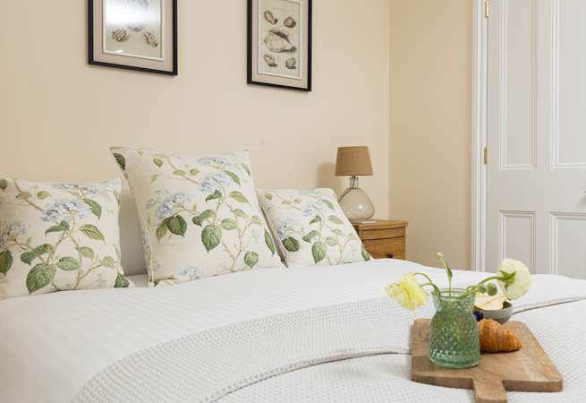 Gorgeous linens and a comfy king-size bed await in bedroom 1.