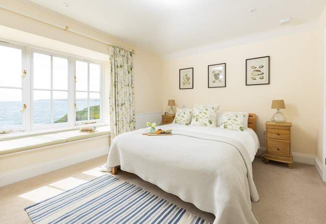 The blissful main bedroom has captivating views.