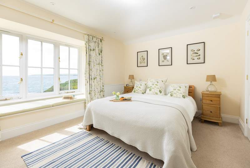 The blissful main bedroom has captivating views.