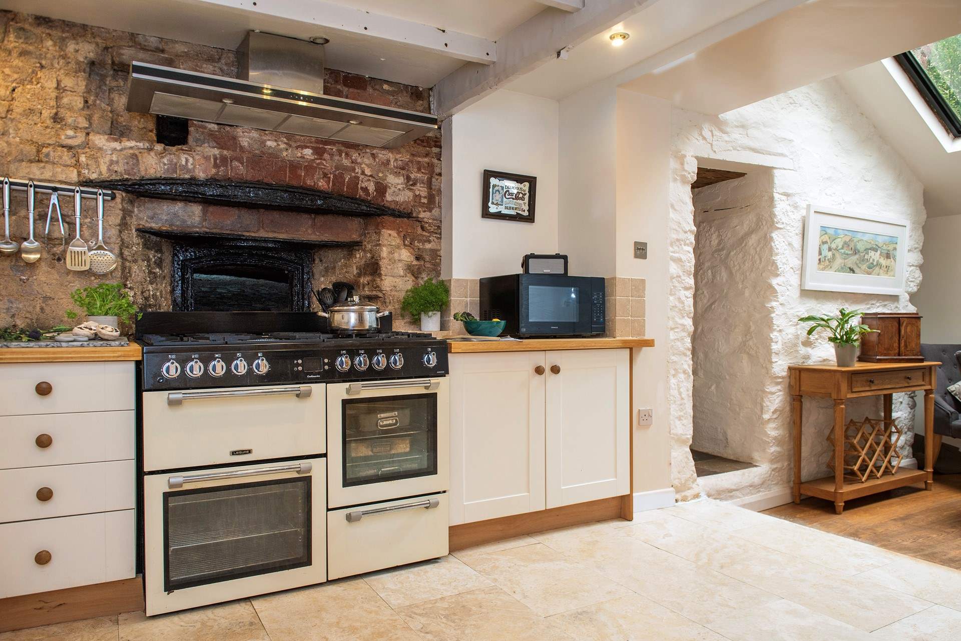 Once the village bakery, sitting behind the modern range cooker is the original bread oven and it is huge.