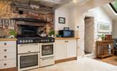 Once the village bakery, sitting behind the modern range cooker is the original bread oven and it is huge. - Thumbnail Image