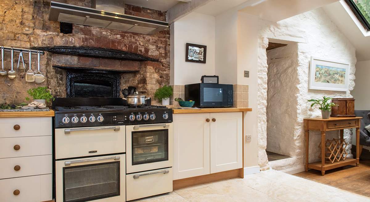 Once the village bakery, sitting behind the modern range cooker is the original bread oven and it is huge.