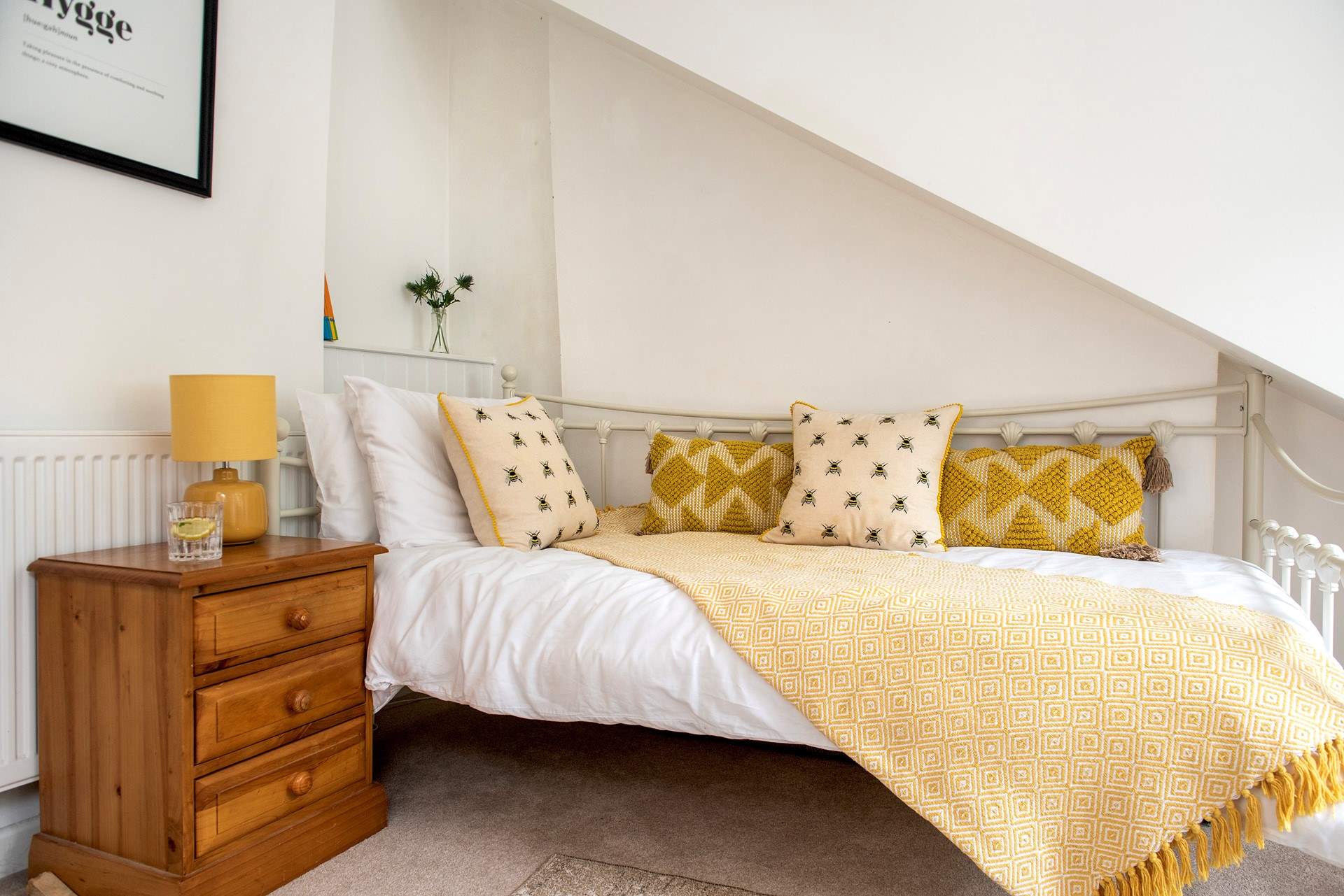 Pretty throws and cushions adorn the bed.