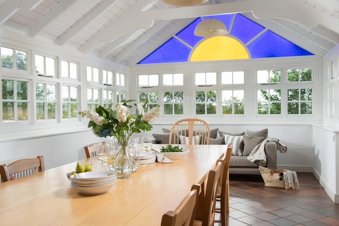 The open plan kitchen/diner, with a comfortable sofa and this absolutely stunning stained window!