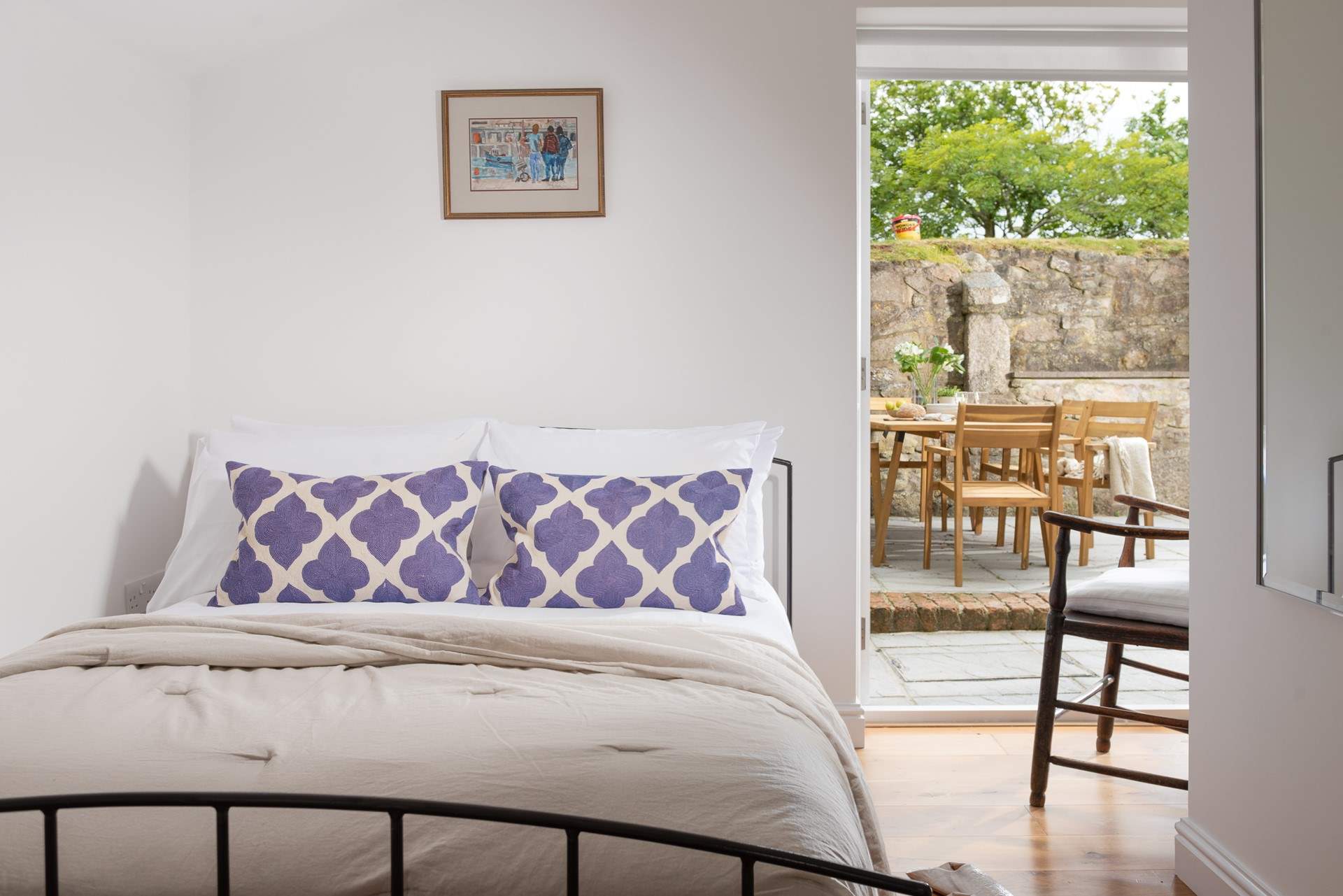 Bedroom 1 is a cosy double room with French doors leading out to the terrace.