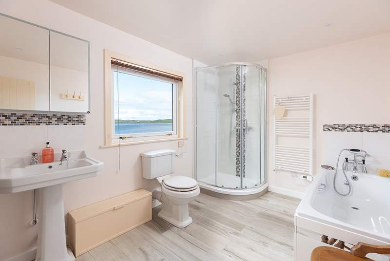 The spacious family bathroom with bath and separate shower has more views.