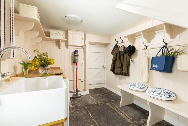 The boot-room with laundry is perfect for storing outdoor wear.