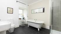 The en suite to bedroom 2 has an indulgent freestanding bath.