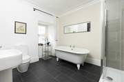 The en suite to bedroom 2 has an indulgent freestanding bath.