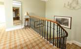 The spacious landing showcasing the wide curved staircase and leading to the bedrooms. - Thumbnail Image