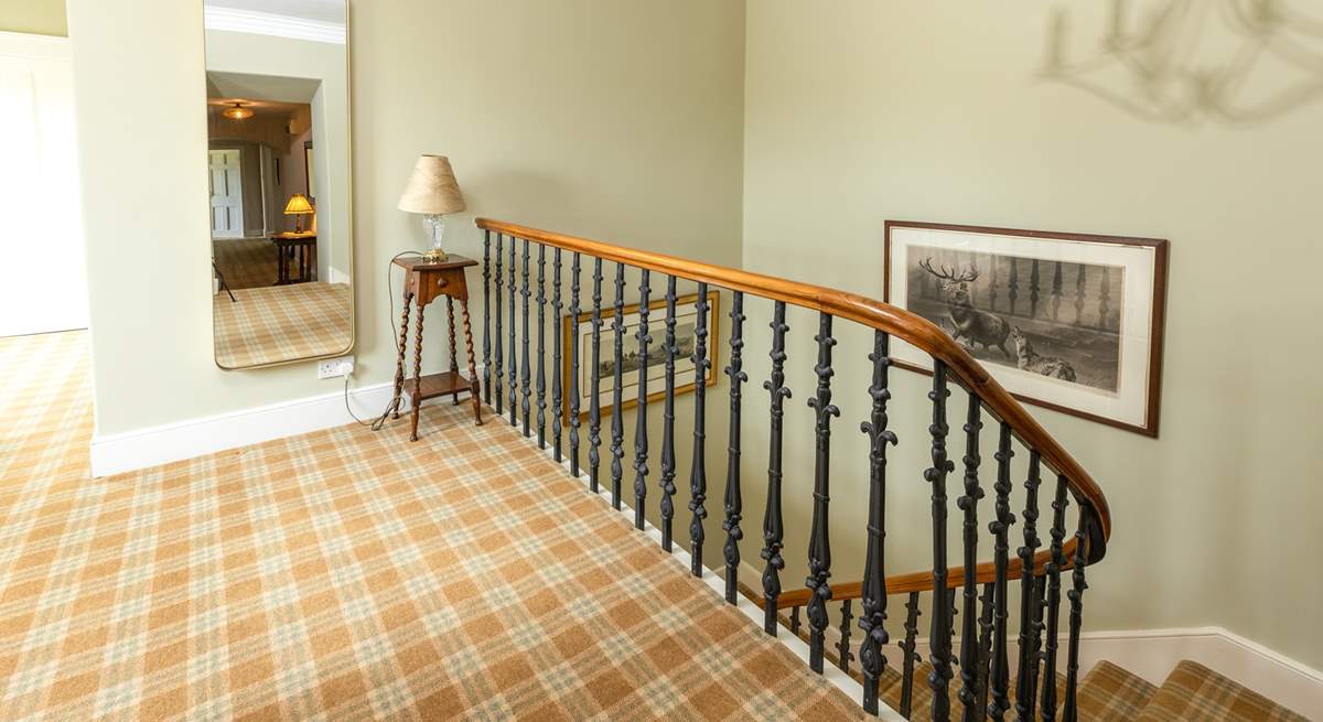 The spacious landing showcasing the wide curved staircase and leading to the bedrooms.