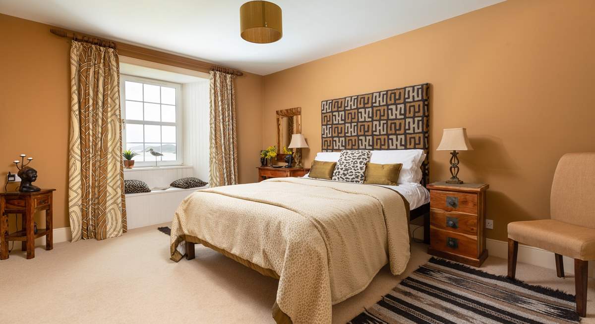 This stylish bedroom has an en suite shower-room and a window seat with views.