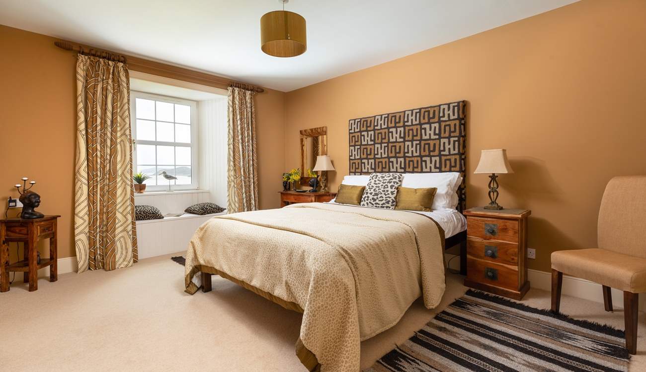 This stylish bedroom has an en suite shower-room and a window seat with views.