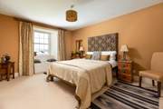 This stylish bedroom has an en suite shower-room and a window seat with views.