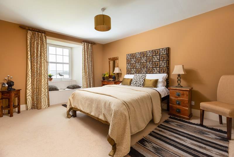 This stylish bedroom has an en suite shower-room and a window seat with views.