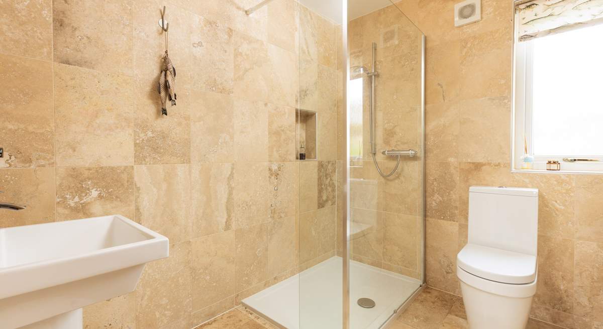 The modern shower-room has a stylish shower.