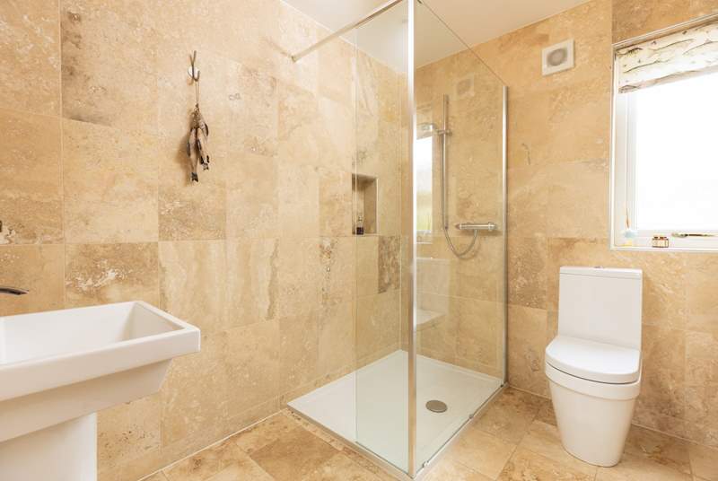 The modern shower-room has a stylish shower.