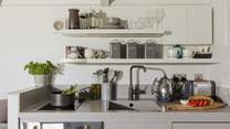 The stylish kitchen is well equipped with everything you'll need during your stay.