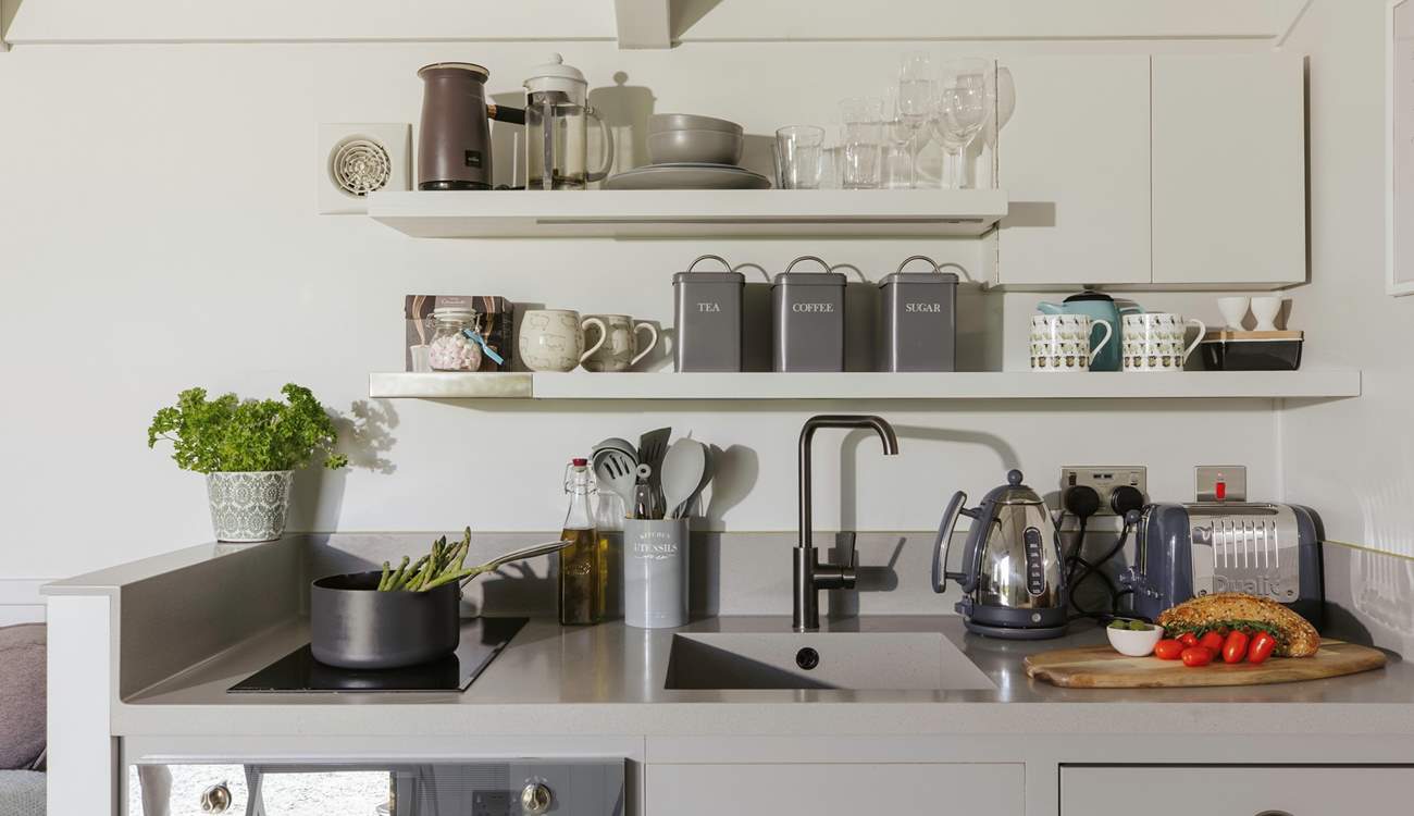 The stylish kitchen is well equipped with everything you'll need during your stay.