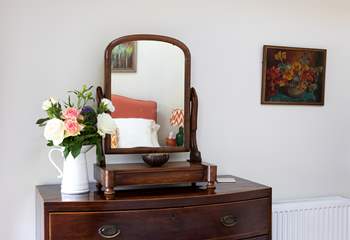 Delightful vintage furniture adorns bedroom 1.