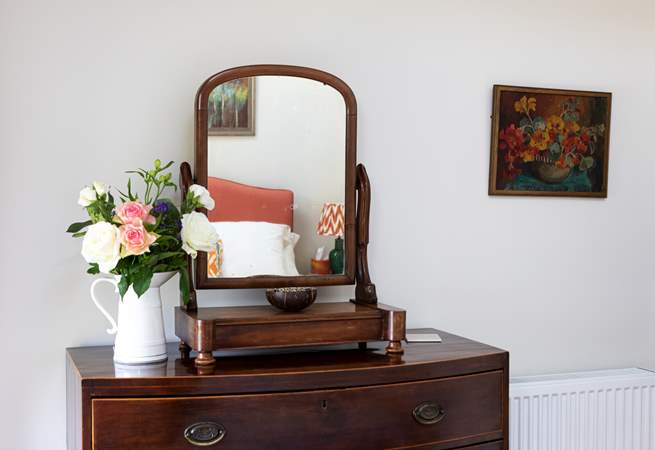 Delightful vintage furniture adorns bedroom 1.