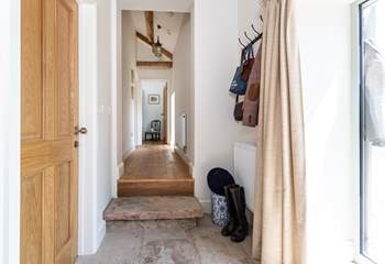 Original stone floors and beams grace the hallway. Please take care on the stone step here.