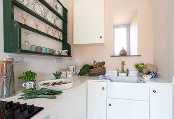 Vintage crockery adorns the dresser in the contemporary kitchen.