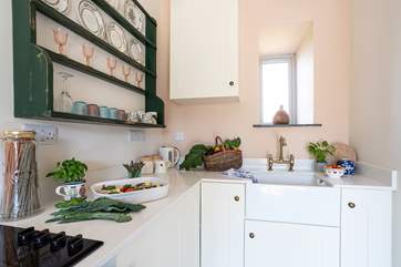 Vintage crockery adorns the dresser in the contemporary kitchen.