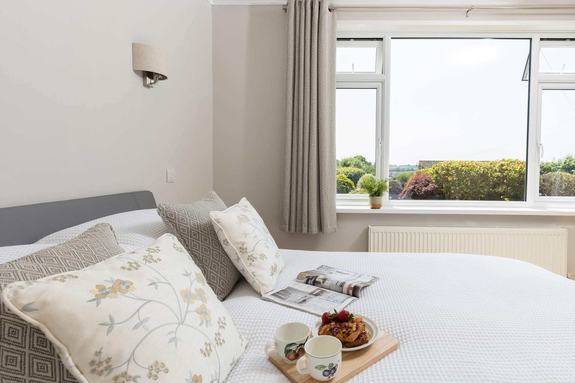Bedroom 1 has a lovely outlook of the well maintained garden area.