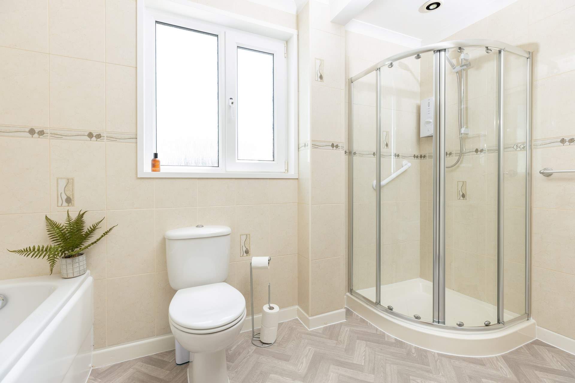 The spacious family bathroom is situated between bedroom 1 and 2. It features a bath with separate shower cubicle, WC, and wash-basin.