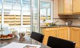 There is a delightful breakfast-bar that has plenty of natural light from the conservatory and looks over to the open plan dining/living-room.  - Thumbnail Image