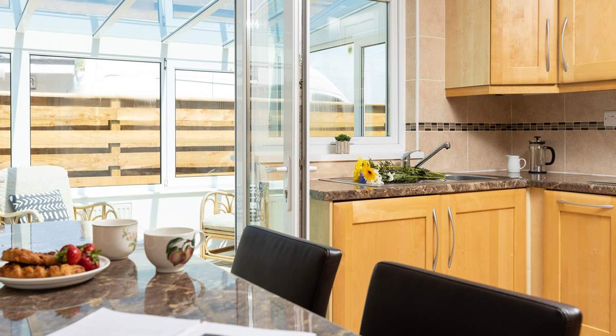 There is a delightful breakfast-bar that has plenty of natural light from the conservatory and looks over to the open plan dining/living-room. 