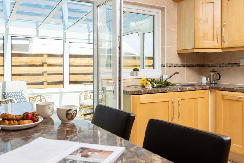 There is a delightful breakfast-bar that has plenty of natural light from the conservatory and looks over to the open plan dining/living-room. 