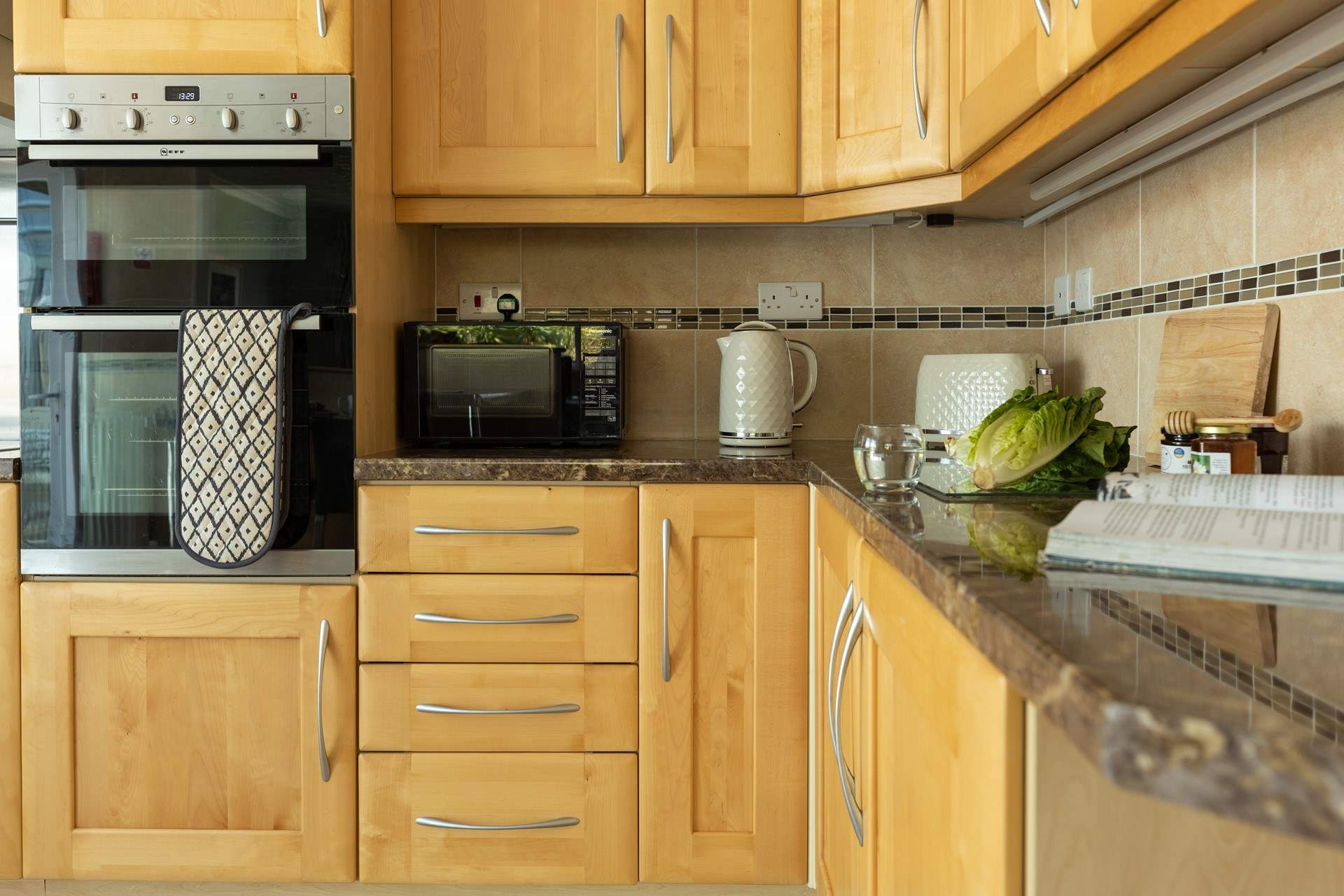 There is everything you might need in this well equipped kitchen. 