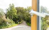 Looking out on to a quiet country lane. Mylor Creek is to the right and Weir beach, part of Restronguet creek, is a short stroll to the left. - Thumbnail Image