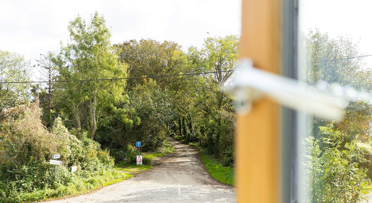 Looking out on to a quiet country lane. Mylor Creek is to the right and Weir beach, part of Restronguet creek, is a short stroll to the left.