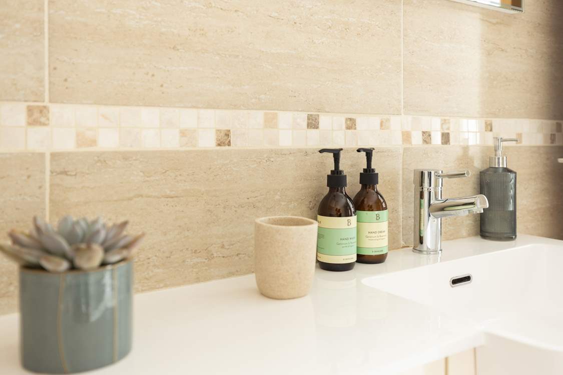 The family bathroom has a bath with shower overhead.