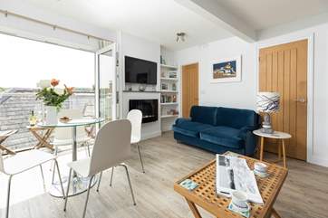 The patio doors let the fresh air into the gorgeous living space.