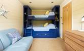 The bunk room has a four-foot bottom bunk so can accommodate two small children. Please note the single top bunk is not to be used by guests. - Thumbnail Image