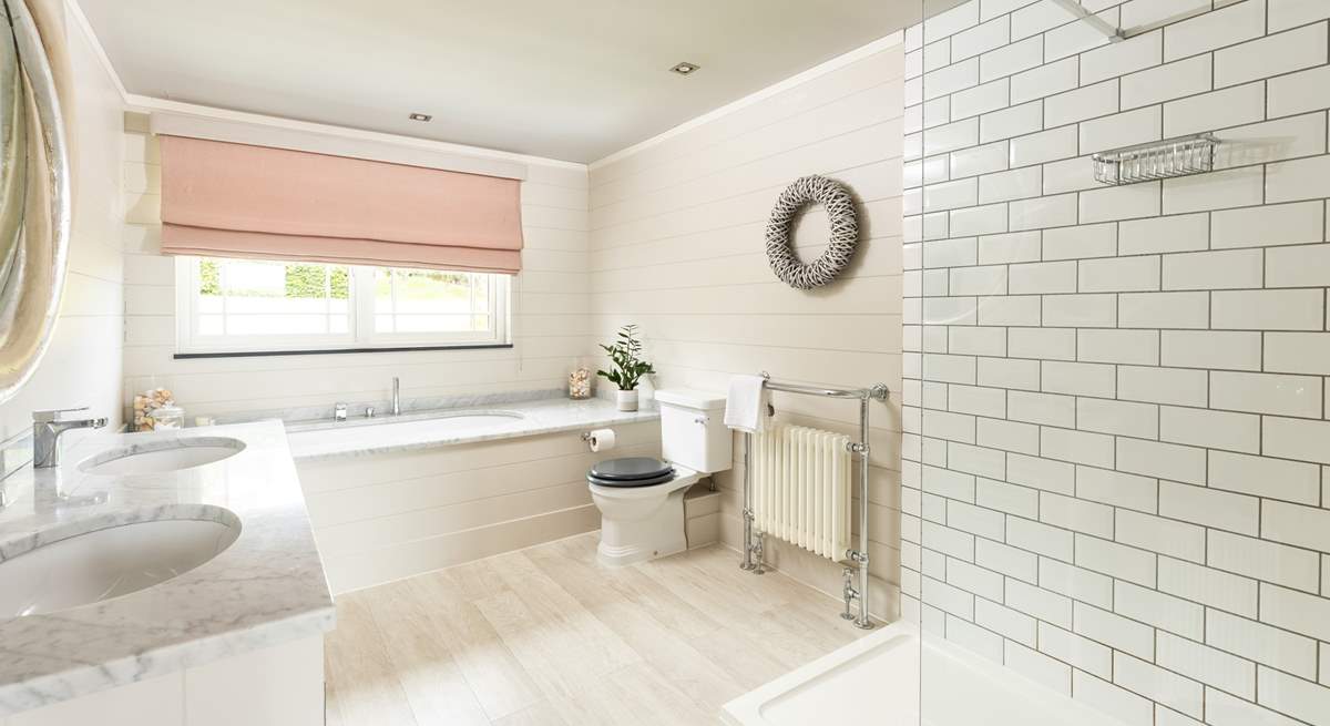 The fabulous en suite bathroom to bedroom 1 has a gorgeous bath, large shower and double sinks.