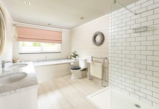 The fabulous en suite bathroom to bedroom 1 has a gorgeous bath, large shower and double sinks.
