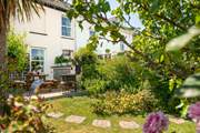 The garden is a fabulous spot for sun-soaked dining, with a cute terrace area with table and chairs, perfect for those sunny lunches and Cornish cream teas. (Please note, the chiminea and barbecue have been replaced with a portable fire-pit/barbecue).