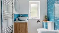 The family bathroom is bright and modern.