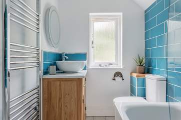 The family bathroom is bright and modern.