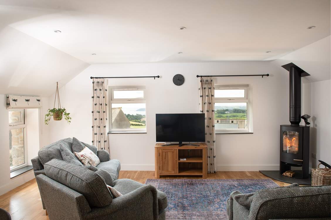 Snuggle around the wood-burner on chillier days with a good book...and enjoy the distant sea views.