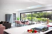 The open plan living area is light and spacious with bi-folding doors opening to the patio and garden.