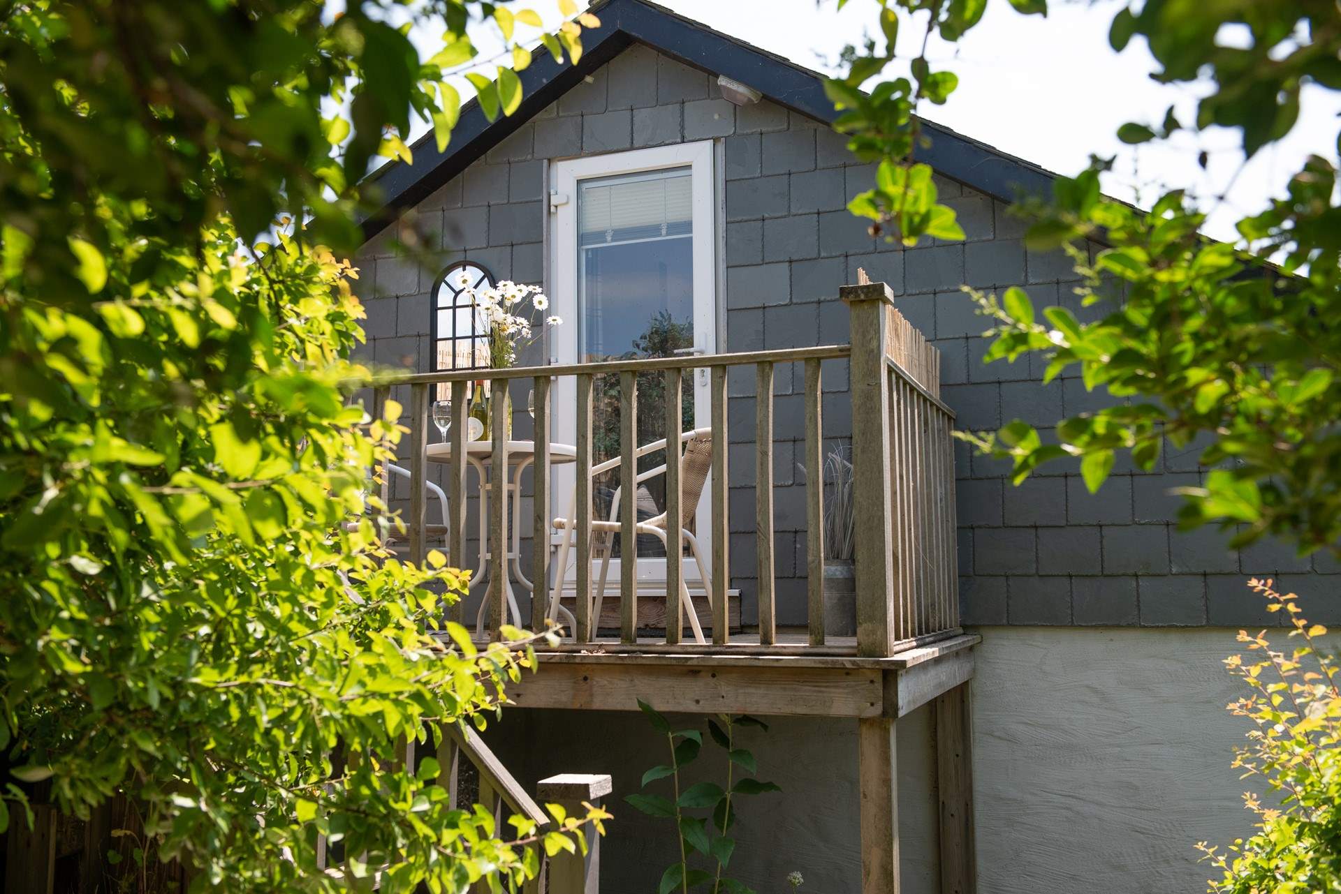 Steps lead down from the balcony to the secluded garden.