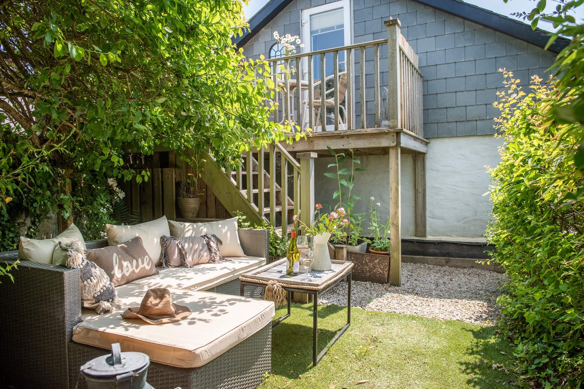 From the deck take the steps down to a secluded garden where you will find a table and sofa. We think this is the perfect spot for an intimate al fresco supper for two.